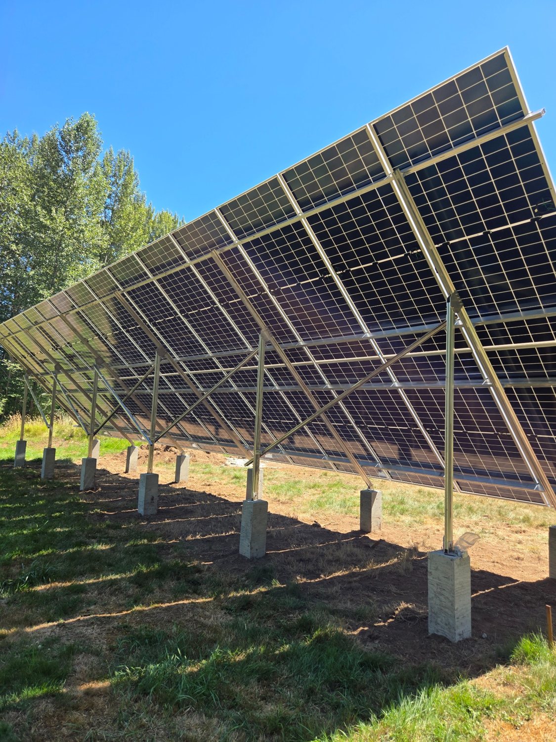 Ground-mounted solar array and engineered structural supports